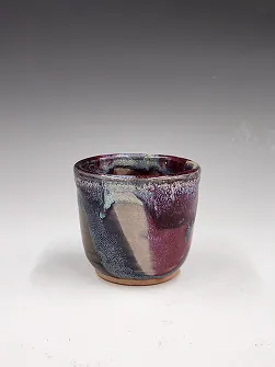 Cup with a purple and blue running glaze.