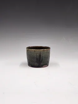 Small dark-glazed cup.