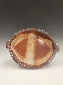 Oval stoneware dish with a two-tone glaze.