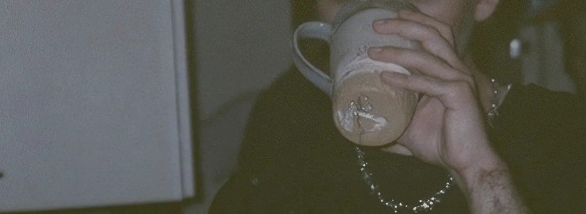 A guest drinking from a ceramic cup.